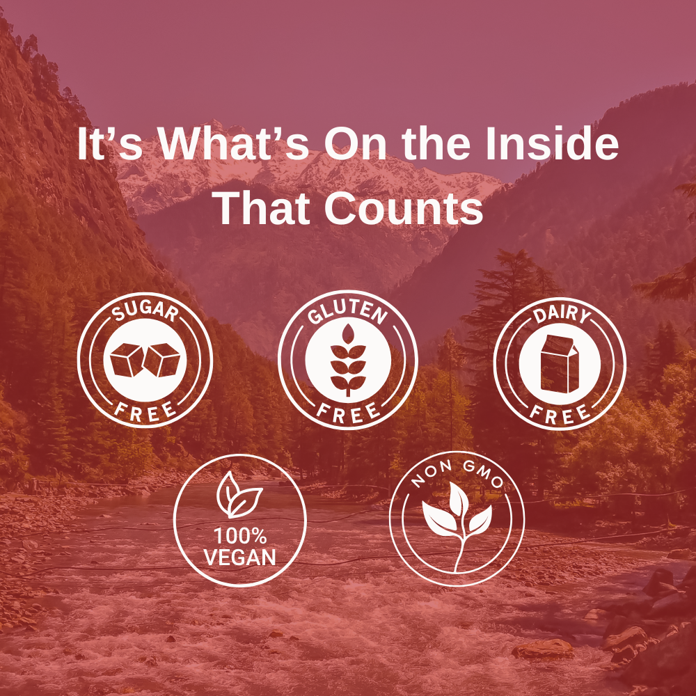 The forest and a stream running underneath the Himalayan mountains with text overlay that states: It's What's On the Inside That Counts: Sugar-Free, Gluten-Free, Dairy-Free, 100% Vegan, Non-GMO.