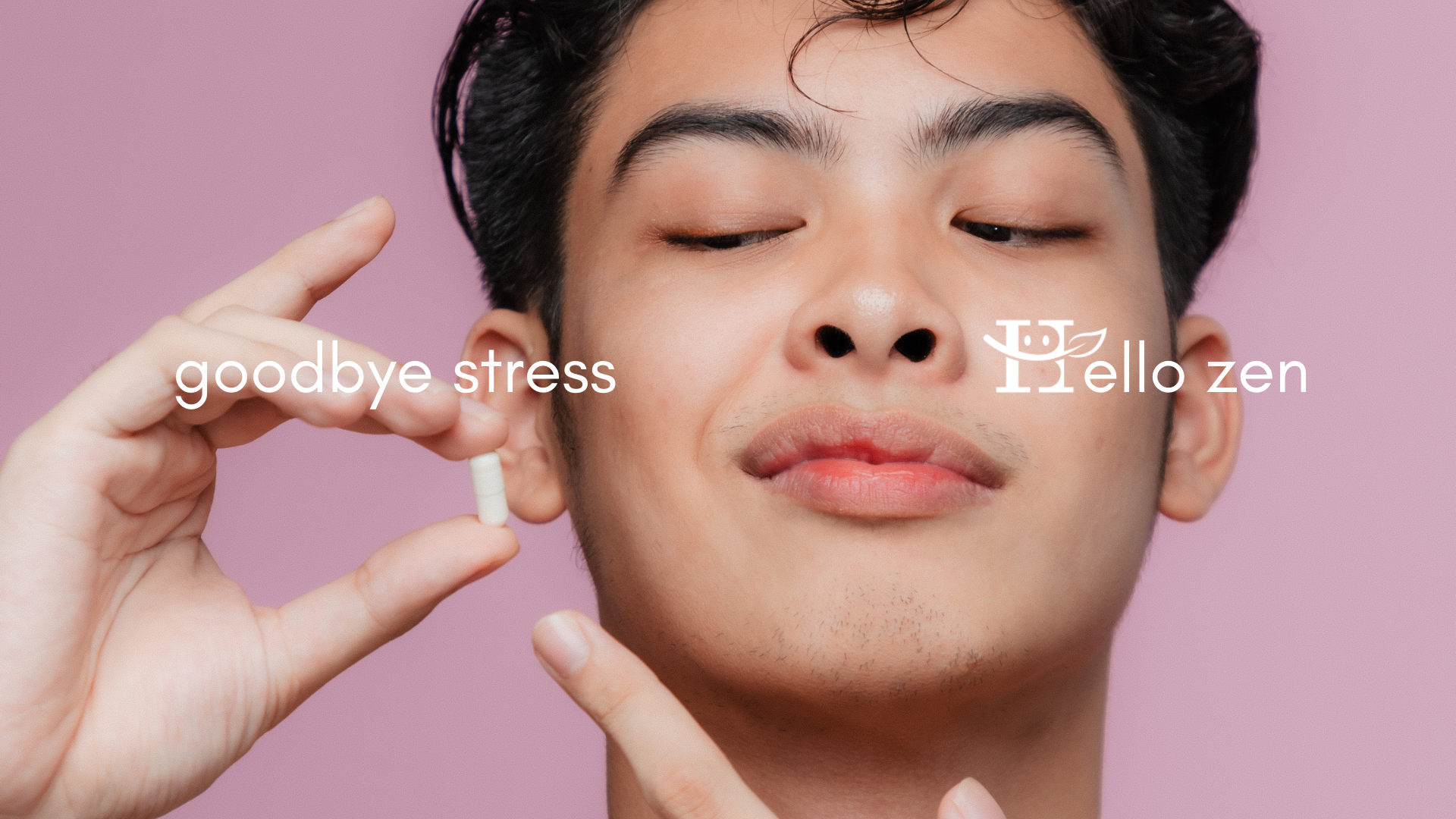 A young man looking down and pointing at a white dietary supplement capsule in between his fingers, standing in front of a soft pink background. Text states: Goodbye stress, hello zen.